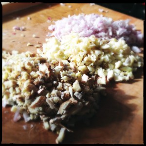 Shallots, garlic, and ginger, chopped and ready to softened.